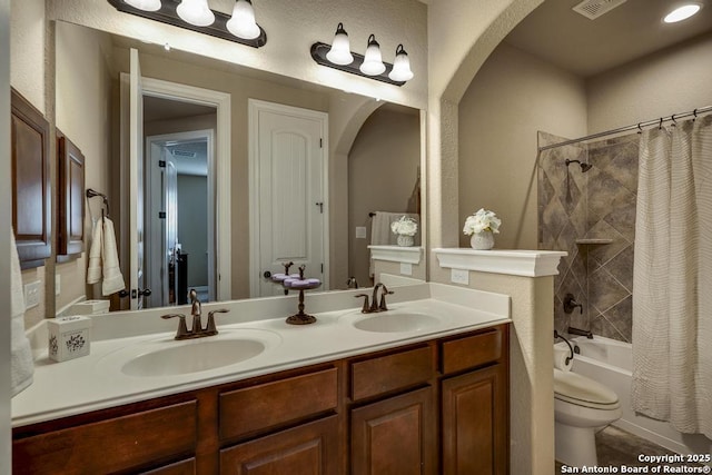 full bathroom with vanity, shower / bath combination with curtain, and toilet