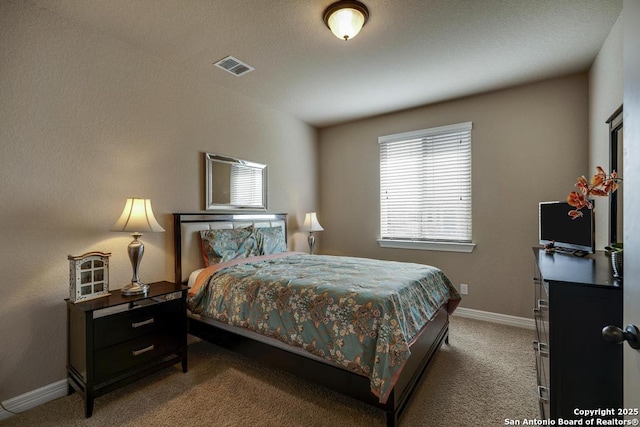 bedroom with carpet, visible vents, and baseboards