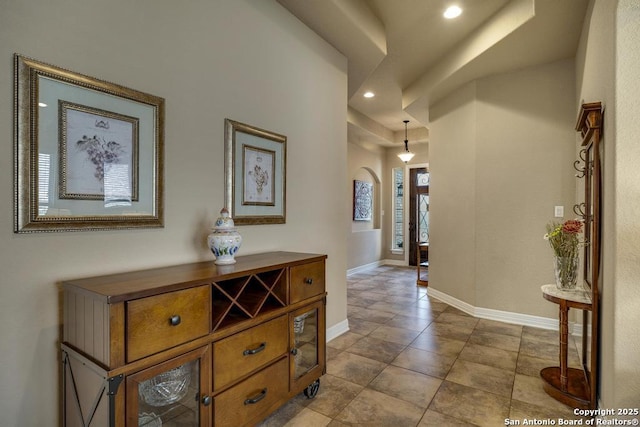 hall featuring baseboards and recessed lighting