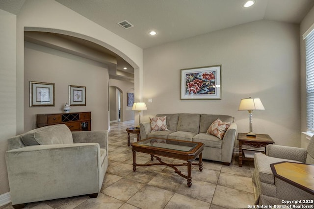 living room featuring lofted ceiling