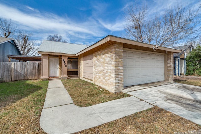 single story home featuring a garage and a front lawn