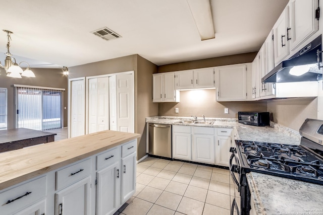 kitchen featuring hanging light fixtures, dishwasher, white cabinets, and gas range oven