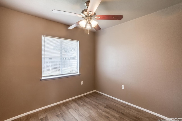 spare room with ceiling fan and wood-type flooring