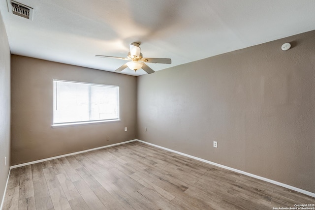 spare room featuring ceiling fan and light hardwood / wood-style flooring