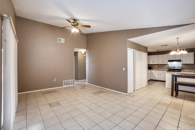 interior space featuring lofted ceiling, white cabinetry, stainless steel range oven, light tile patterned flooring, and ceiling fan with notable chandelier