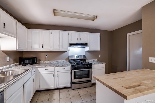 kitchen with white cabinetry, light tile patterned floors, stainless steel appliances, and sink