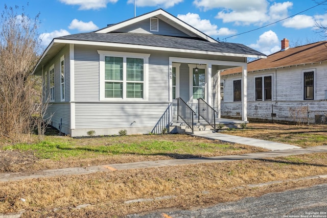 bungalow-style home with a front lawn