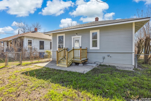 back of house featuring a patio and a lawn