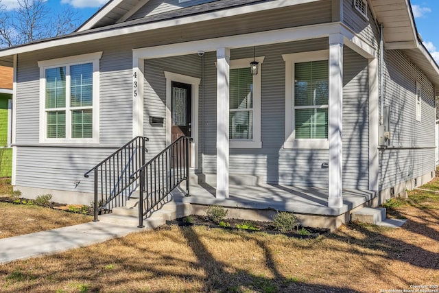 view of exterior entry featuring covered porch