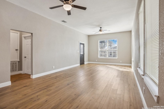 unfurnished room with ceiling fan and light hardwood / wood-style flooring