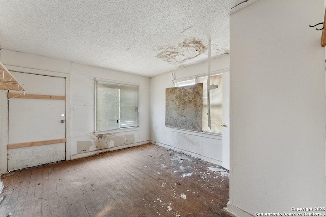 interior space with wood-type flooring and a textured ceiling