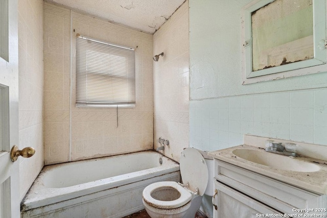 full bathroom with vanity, toilet, tiled shower / bath combo, and tile walls