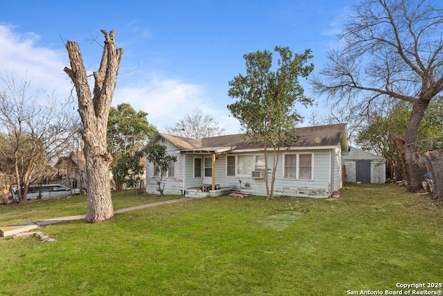 single story home featuring a front yard and cooling unit