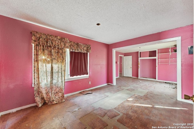 unfurnished bedroom with a textured ceiling