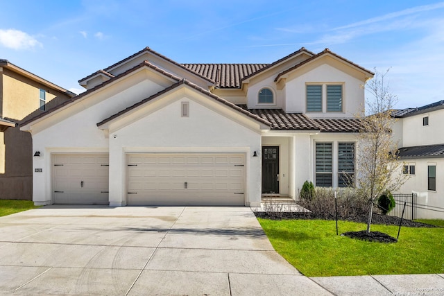 mediterranean / spanish-style home with a garage and a front lawn