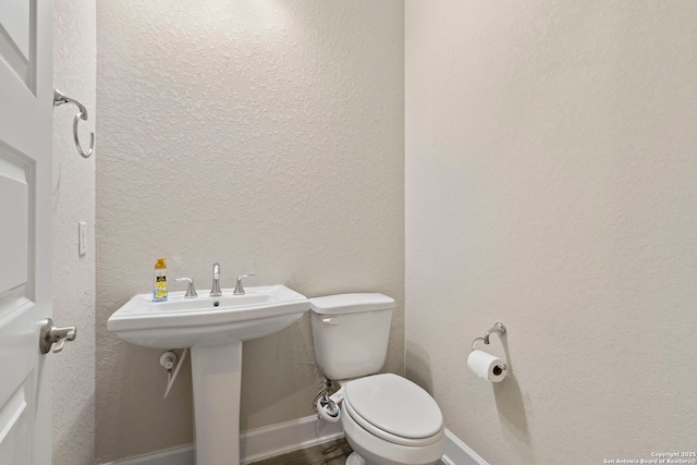 bathroom featuring sink and toilet