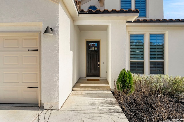 view of exterior entry featuring a garage