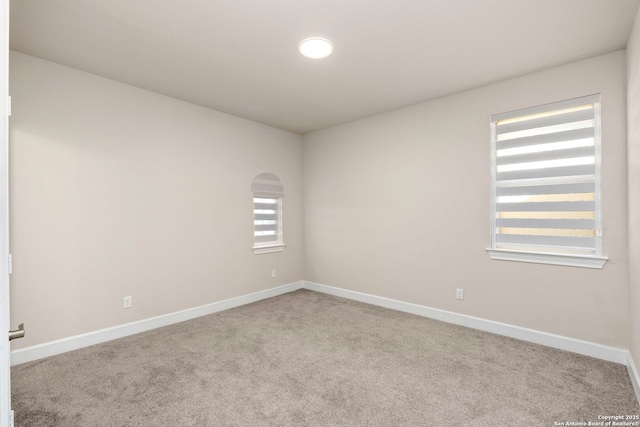 unfurnished room with light colored carpet