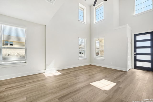 foyer entrance with ceiling fan and light wood-type flooring