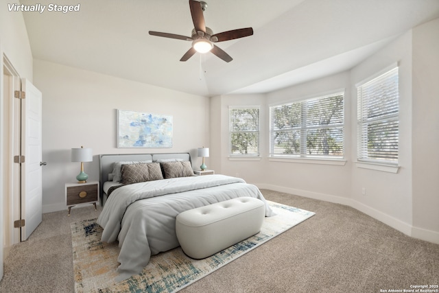 bedroom featuring light carpet, lofted ceiling, and ceiling fan