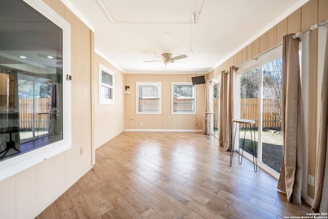 spare room featuring crown molding, light hardwood / wood-style floors, and ceiling fan