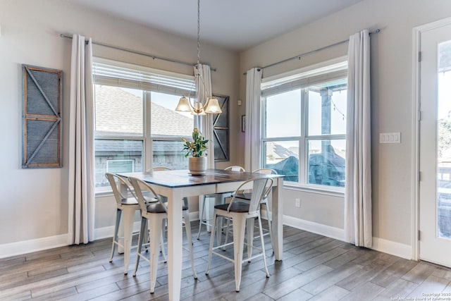 dining area featuring hardwood / wood-style flooring and a chandelier