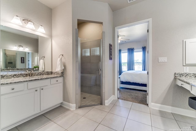 bathroom featuring walk in shower, vanity, and tile patterned flooring