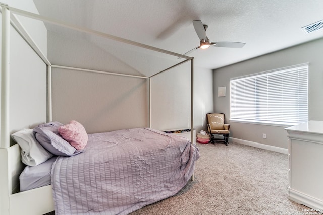 bedroom featuring ceiling fan, carpet floors, and a textured ceiling