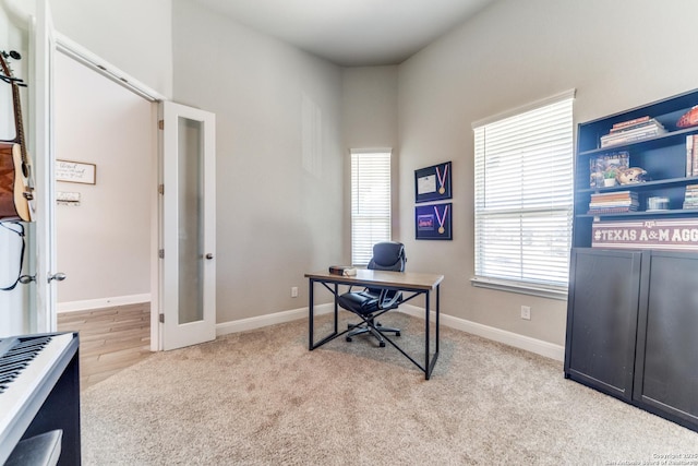 carpeted office featuring french doors