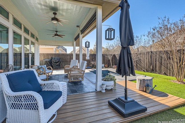 wooden terrace featuring a patio and ceiling fan