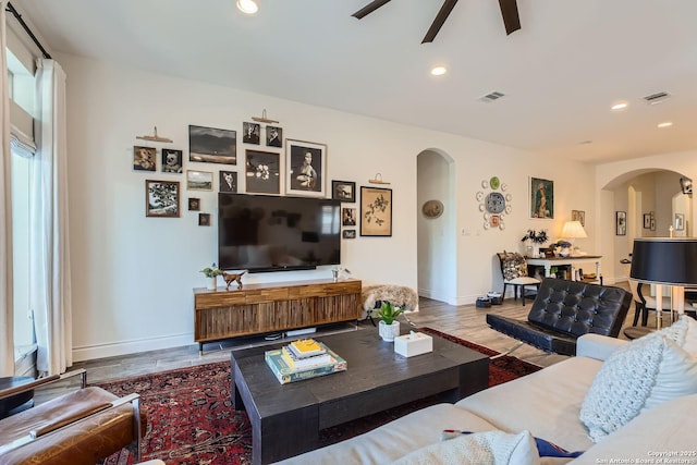 living room with ceiling fan and wood-type flooring