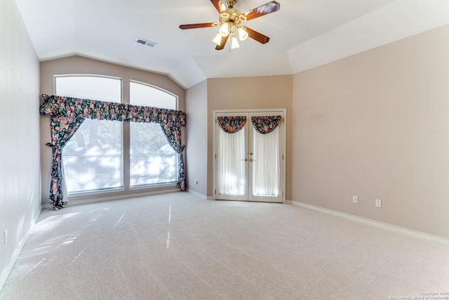 empty room featuring ceiling fan, lofted ceiling, and carpet floors