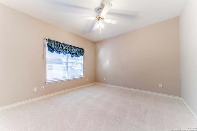 empty room with ceiling fan and light colored carpet