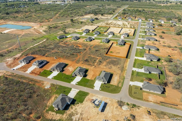 bird's eye view with a residential view and a water view