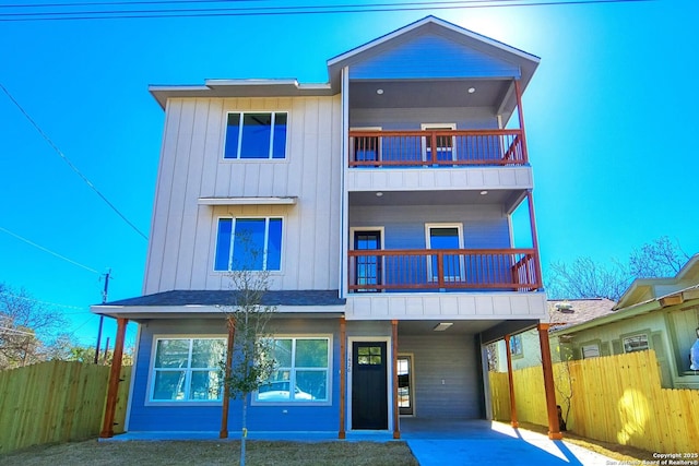 view of front of property with a balcony and a carport