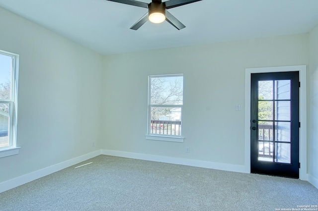 spare room featuring carpet floors and ceiling fan