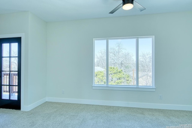 spare room featuring light colored carpet and ceiling fan