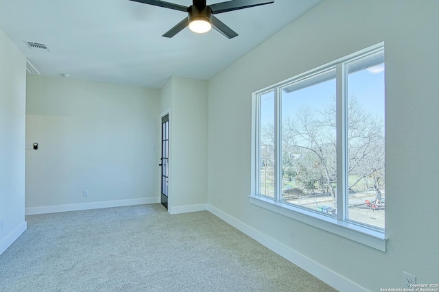 empty room featuring light colored carpet and ceiling fan