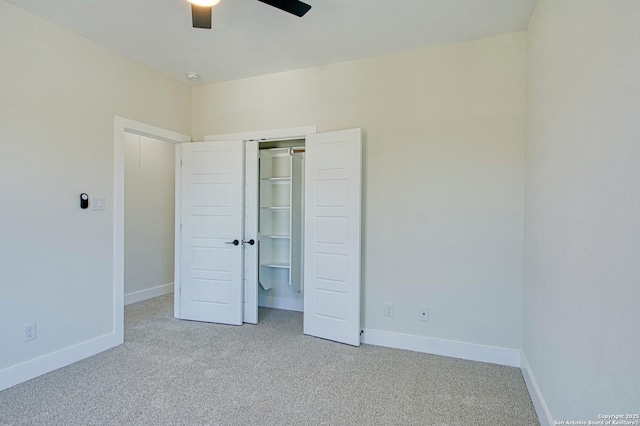 unfurnished bedroom with ceiling fan, a closet, and light carpet