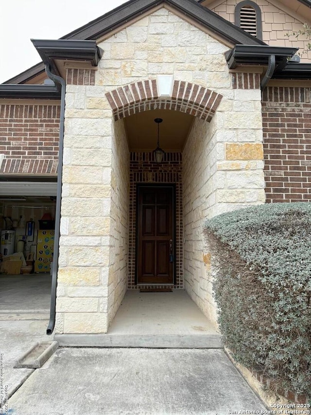 doorway to property with stone siding