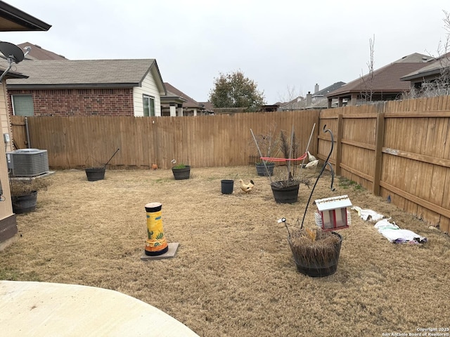 view of yard featuring central AC unit and a fenced backyard