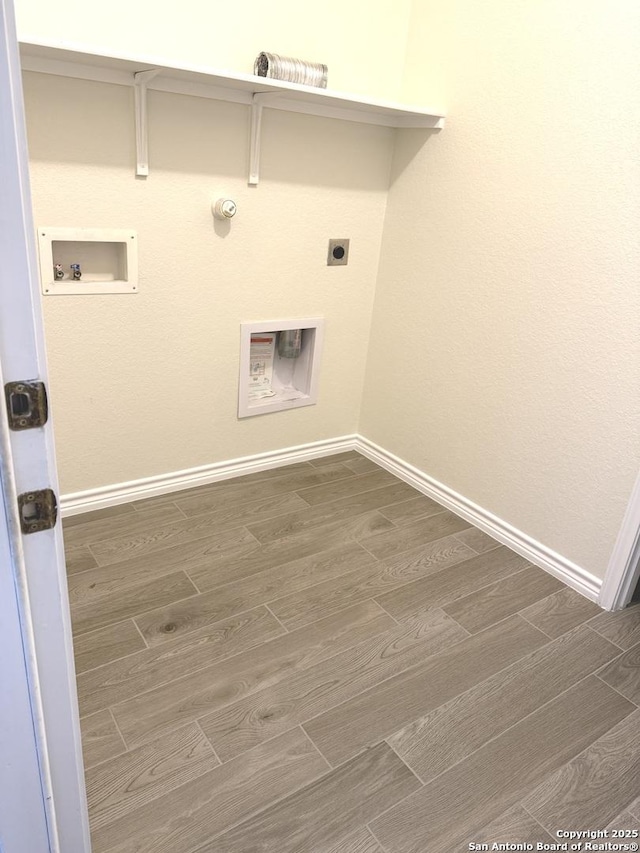 laundry room with hookup for a washing machine, wood tiled floor, hookup for an electric dryer, gas dryer hookup, and laundry area