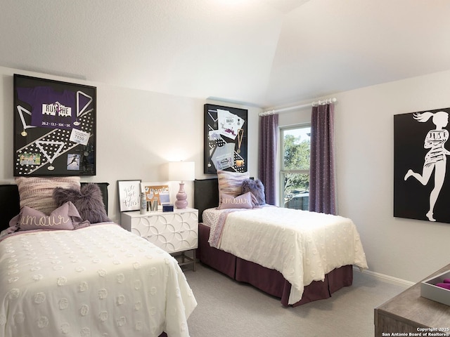 carpeted bedroom with lofted ceiling