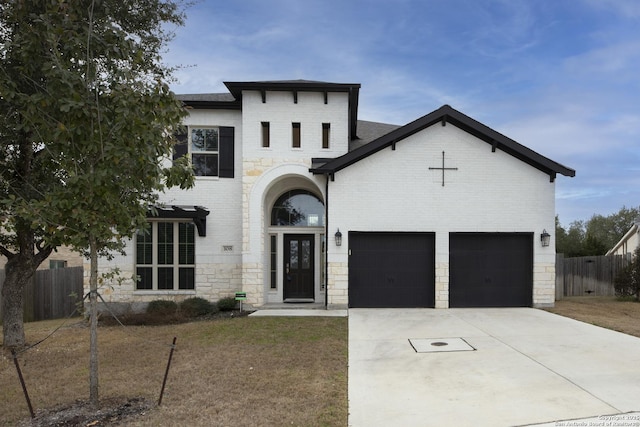 view of front of home with a garage and a front lawn