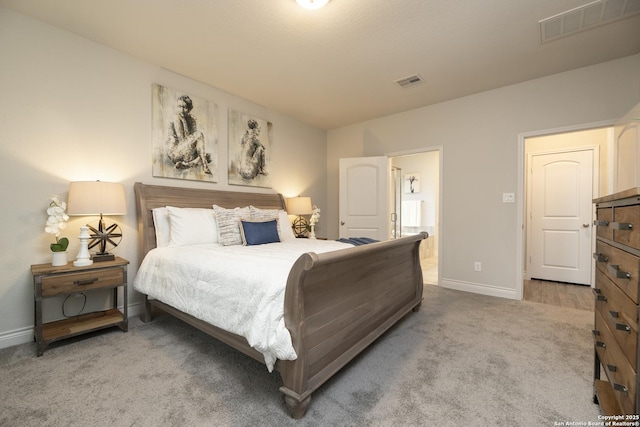 carpeted bedroom with ensuite bath