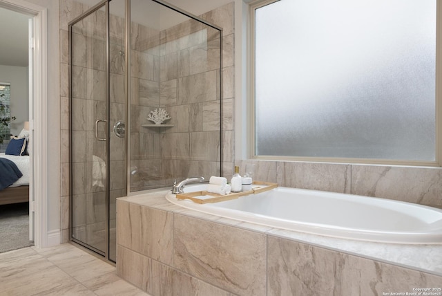 bathroom featuring independent shower and bath and plenty of natural light