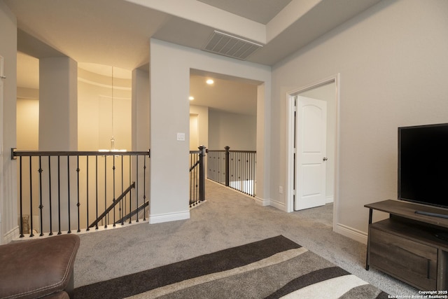 hall featuring light colored carpet