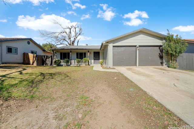 single story home with a porch, a garage, and a front lawn