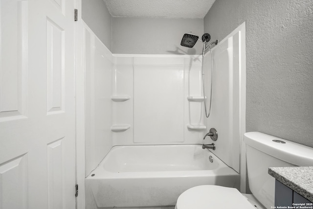 full bathroom featuring toilet, vanity, bathtub / shower combination, and a textured ceiling