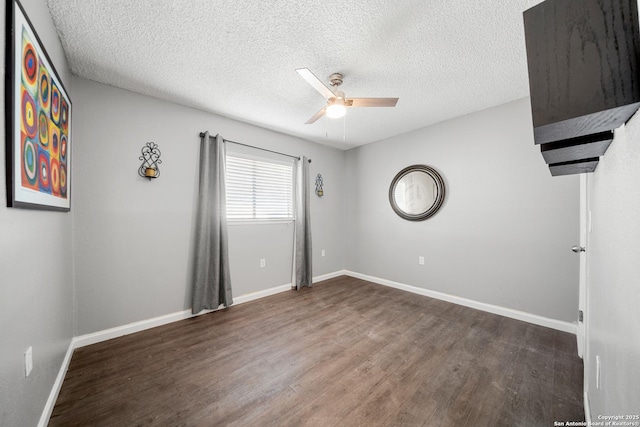 unfurnished room featuring a textured ceiling, dark hardwood / wood-style floors, and ceiling fan